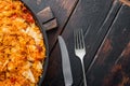 Enchilada with tomato rice, a mexican recipe, on old dark wooden table background, top view flat lay with copy space for text