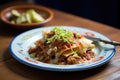 enchiladas smothered in chili con carne and onions