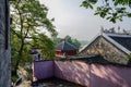 Enclosed ancient tile-roofed buildings in sunny spring morning