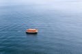 Enclosed rigid lifeboat awaiting rescue in the wide expanse of t