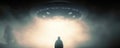 Encounter with Extraterrestrial: Silhouette of a man standing in awe in front of a glowing alien spaceship hovering in the sky Royalty Free Stock Photo