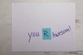 Encouraging message hand written on white paper you are awesome background