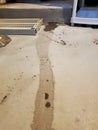 Initial seepage of floodwaters encroach through sealed crack in basement floor Royalty Free Stock Photo