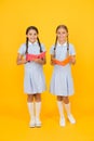 Encyclopedia book for children. small girls love literature. old school. happy friends in retro uniform. vintage kid Royalty Free Stock Photo