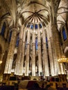 End of church inside lightning light shining stone roof top altar empore blue windows indoor cathedral Barcelona spain