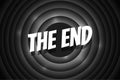 The End comic style text on black circle retro cinema screen. White title on old silent movie ending background