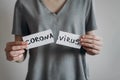 End of a coronavirus quarantine concept. Woman tears the paper with the word Coronavirus. Pandemic of COVID-19 is over Royalty Free Stock Photo