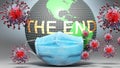 The end and covid - Earth globe protected with a blue mask against attacking corona viruses to show the relation between The end