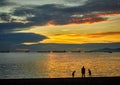 Sunset at Stanley Beach Vancouver Canada, 3 silhuettes in foreground Royalty Free Stock Photo