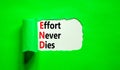 END effort never dies symbol. Concept words END effort never dies on beautiful white paper. Beautiful green paper background.