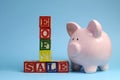 End of Financial Year sale message on building blocks with piggy bank Royalty Free Stock Photo