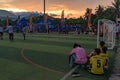 End of football tournament, players siting on the sward.