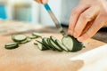 Fresh cucumber being under the knife.