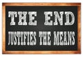 THE END JUSTIFIES THE MEANS words on black wooden frame school blackboard Royalty Free Stock Photo