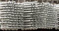 Side view of piles of aluminium construction pipes Royalty Free Stock Photo