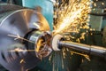 End processing of a metal surface with an abrasive stone on a circular grinding machine, sparks fly in different directions Royalty Free Stock Photo