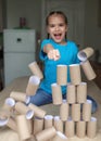 End of quarantine, happy girl beating the wall of paper toilette rolls, kept after lockdown, new normal