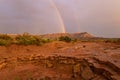 The end of the rainbow arcs over Gooseberry Mesa in Southern Utah USA Royalty Free Stock Photo