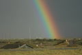 The end of the rainbow. A rainbow seems to hit the ground in the flat land