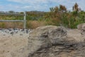 A worn layered rock eroded by the wind and sand sits at the end of an old road Royalty Free Stock Photo