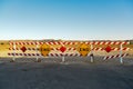 End of road signs and red and white striped barrier Royalty Free Stock Photo