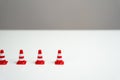 The end of a row of traffic cones on a white background. Royalty Free Stock Photo