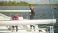 End of the sailing season. On a cold autumn day, female sailing athletes dismantle the rigging of the yacht for winter Royalty Free Stock Photo