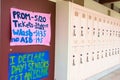 End of the school year signified by color prom signs and rows of book lockers.