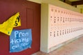 End of the school year signified by color prom signs and rows of book lockers.