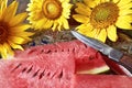 A bouquet of sunflowers and a watermelon as a sign of the end of summer on a beautiful tray