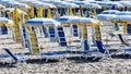 End of summer - Parasols and sun loungers closed on the beach