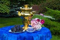 The end of the summer. Samovar, cups of tea, flowers and gifts o