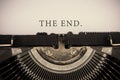 The end text typed on an old vintage typewriter. Conceptual Royalty Free Stock Photo