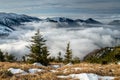 End of winter in Mountains. Mist in valley, snow on the hills in background