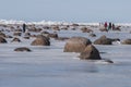 Springtime with stones and melting ice stacks in Gulf of Riga near to Mersrags