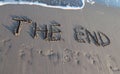 THE END written on the beach while the wave comes Royalty Free Stock Photo