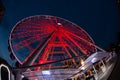 a ferris wheel illuminated in red color overview at night Royalty Free Stock Photo