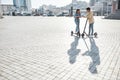 End your weekend by riding a vehicle. Friends using electric scooter on a sunny day Royalty Free Stock Photo