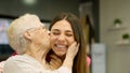 Endearing image of a grandmother kissing her granddaughter