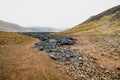 The ending of black volcanic rocks stoping in the valley near Geldingadalir active Volcano