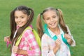 Ending of school year. Cheerful smart schoolgirls. Happy schoolgirls outdoors. Small schoolgirls with backpacks