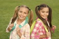 Ending of school year. Cheerful smart schoolgirls. Happy schoolgirls outdoors. Small schoolgirls with backpacks