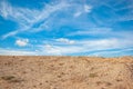 Endless azure sky with white clouds, sandy shore, beach. Calm inspiring view Royalty Free Stock Photo