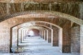 Endless brick passage with repeating archways in Fort Jefferson on Dry Tortugas National Park. Royalty Free Stock Photo