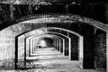 Endless brick passage with repeating archways in Fort Jefferson on Dry Tortugas National Park. Royalty Free Stock Photo