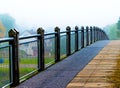 Endless bridge mist over lake Royalty Free Stock Photo