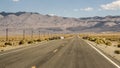 Endless empty road scenic landscape with a desert and mountains in the background in Nevada