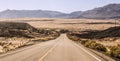 Endless empty road scenic landscape with a desert and mountains in the background in Nevada