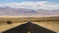 Endless empty road scenic landscape with a desert and mountains in the background in Nevada