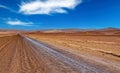 Endless eternally long empty straight desert road, red monotonous vegetationless life hostile flat dry barren arid landscape -